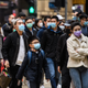 Pedestrians wearing face masks near a Lunar New Year celebration in Hong Kong on Jan. 27, 2020.